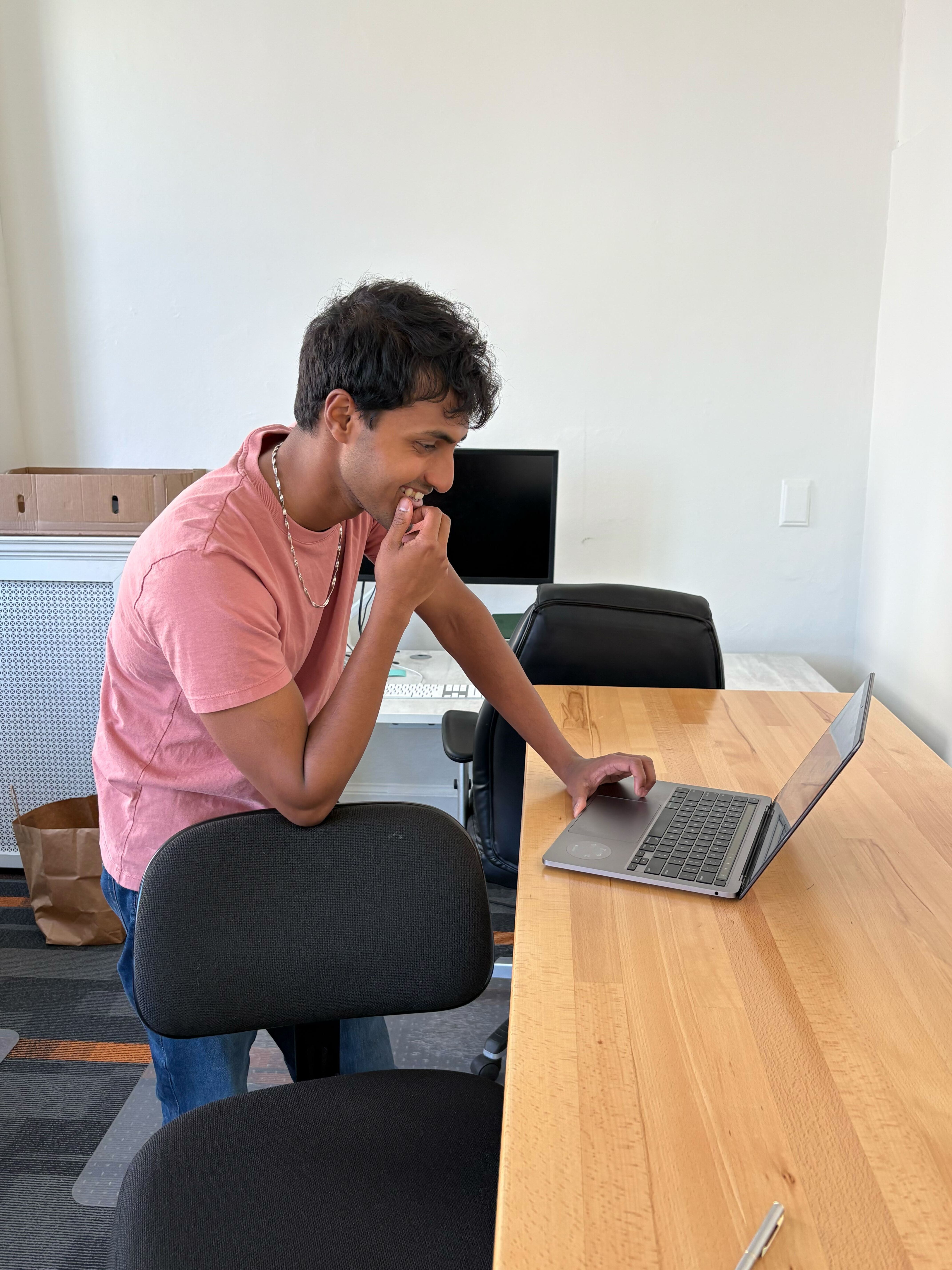 Paurav working at a standing desk in the Cyrus office